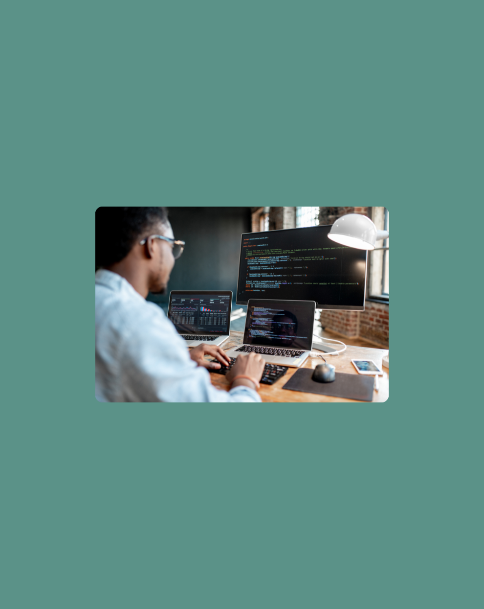 Image of a developer working on his computers. 